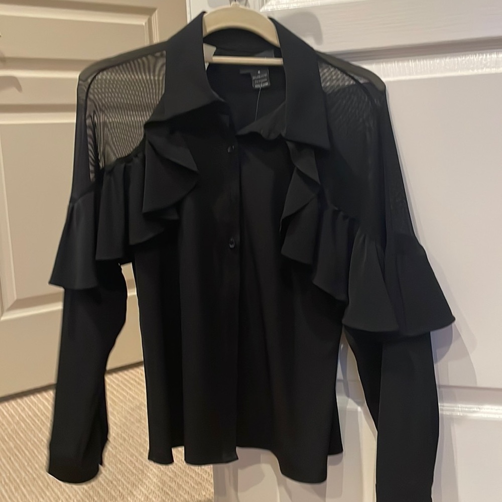 Women’s black blouse with sheer panels and ruffle detail